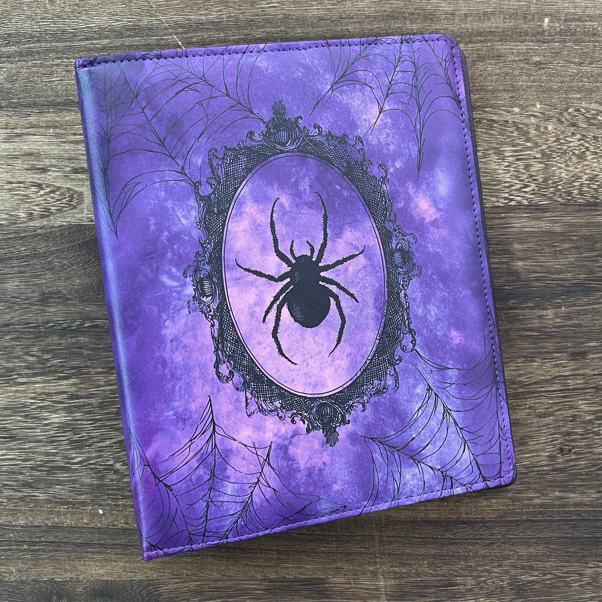 Front cover with spider in oval frame