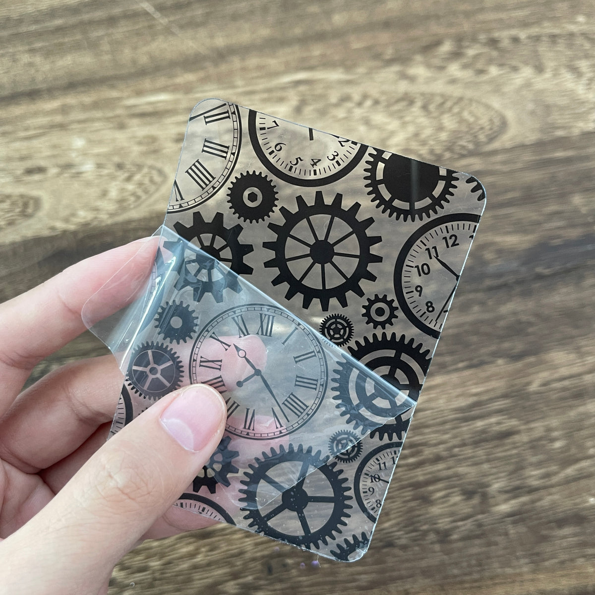 Holding a black gear clear card