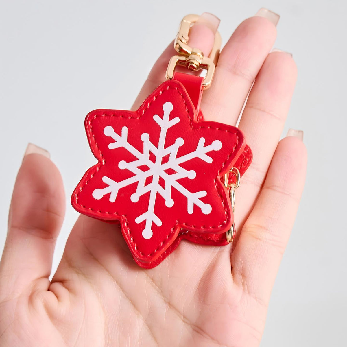 Snowflake charm in hand