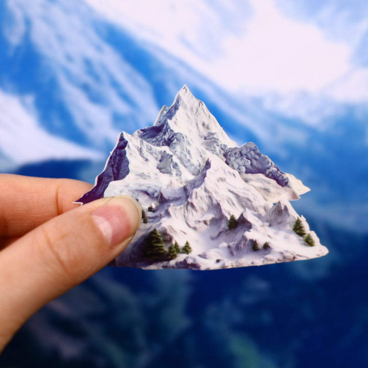 Holding a snowy mountain sticker