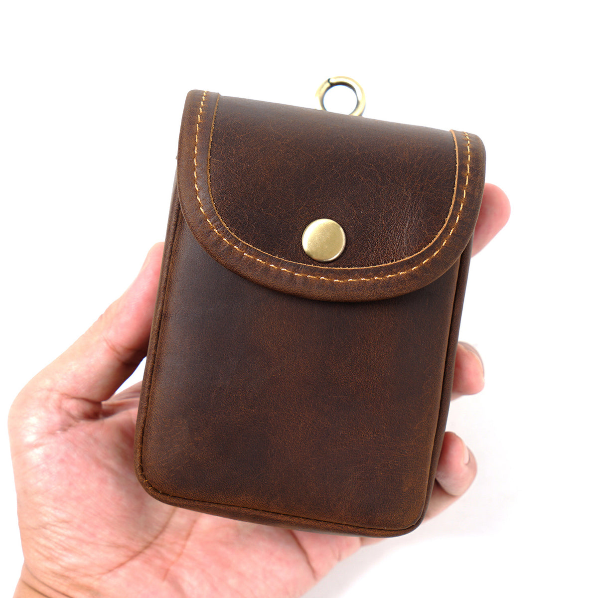 Dark brown pouch in hand