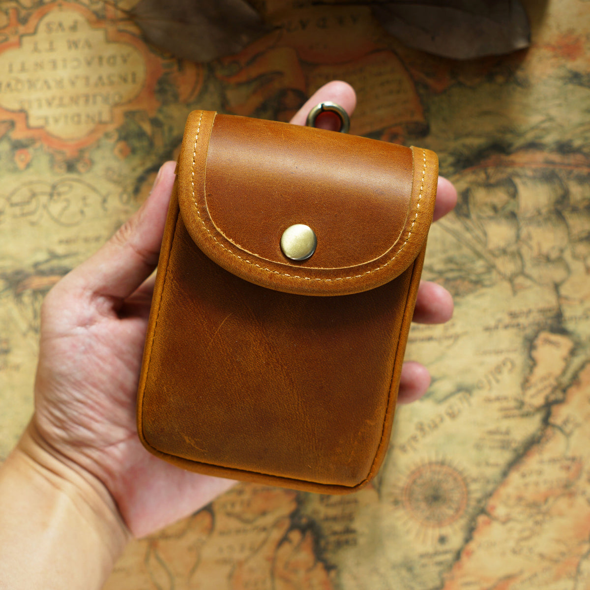 Holding a brown pouch